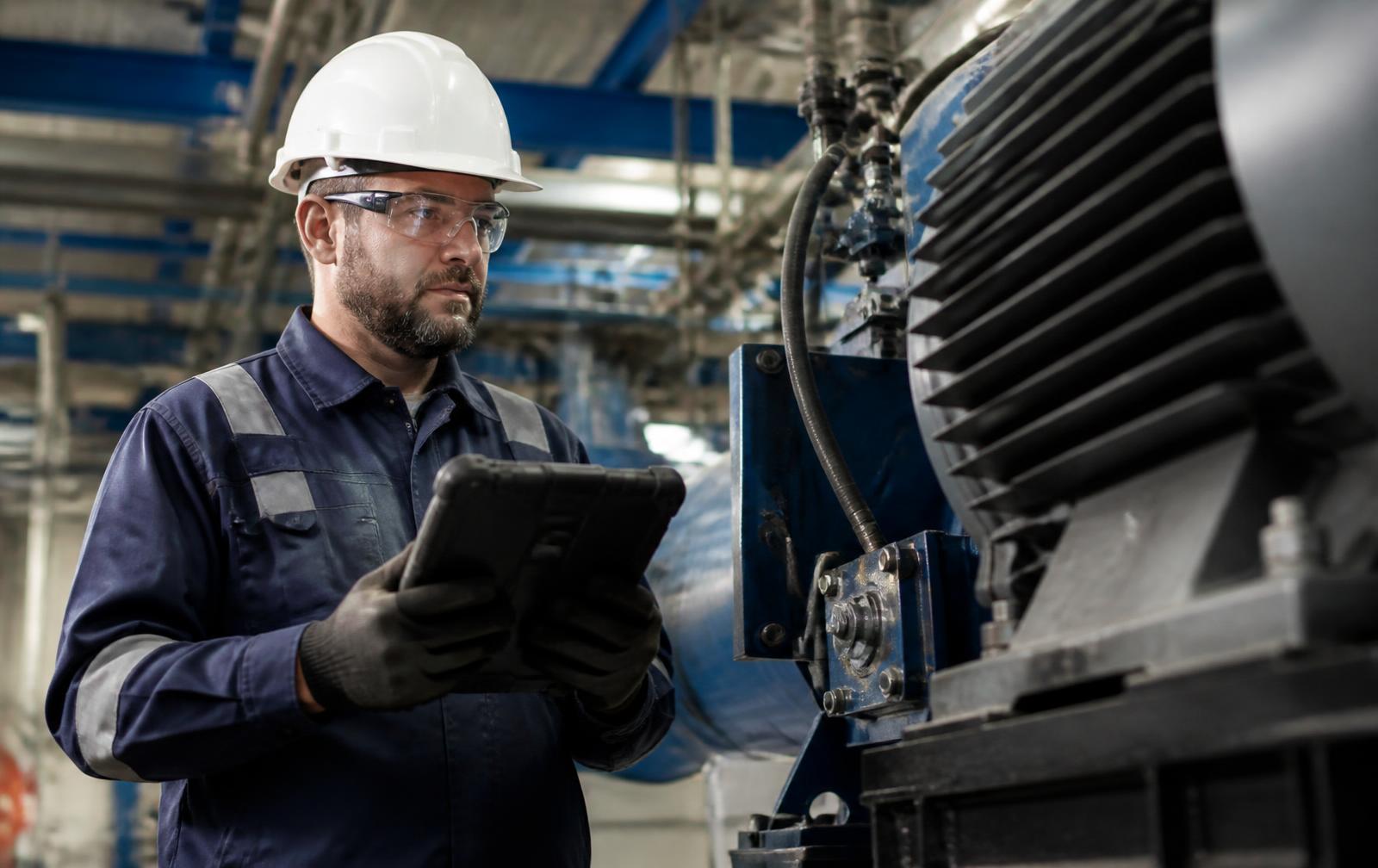 Field technician commissioning industrial monitoring equipment on site